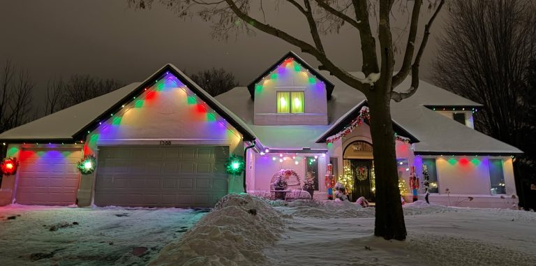colored Govee outdoor permanent lights on snowy residential home