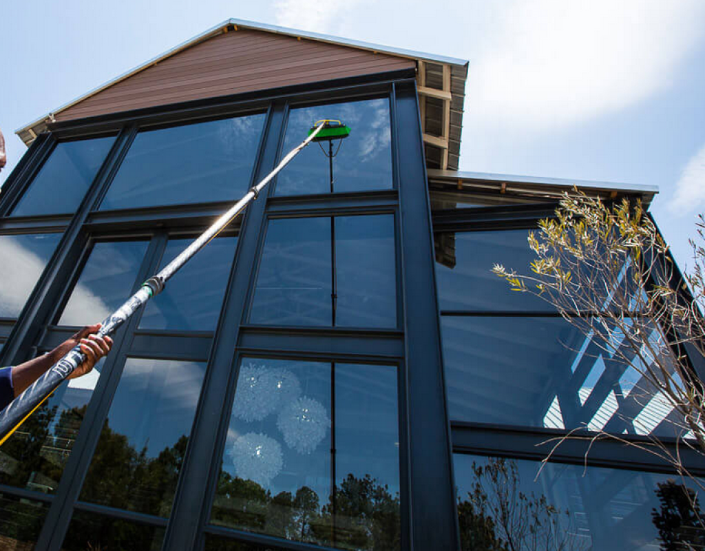 Streak-free window reflecting the sky after professional window washing service